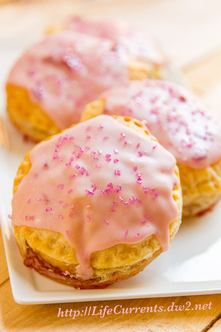 Pink Pop Tarts are filled with Strawberry Jam all wrapped up inside flaky puff pasty, and they're really easy to make! 