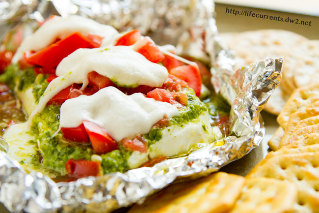Caprese Dip hot off the grill or out of the oven for Tailgating Snacks Month! Dig in to this cheese filled dip with tomatoes and basil! https://lifecurrentsblog.com