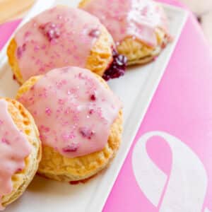 Pink pop tarts on a white tray next to a pink breast cancer awareness ribbon.