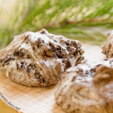Chocolate Cherry Meringue Cookies on a wooden tray.