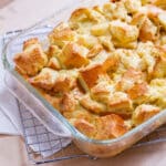 square crop of casserole in a glass baking dish on a wire rack to cool.