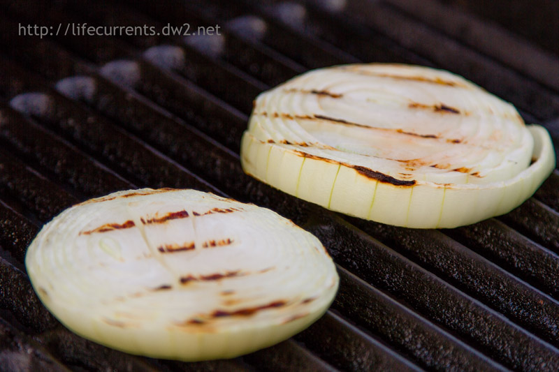 tickly sliced onions on the grill.