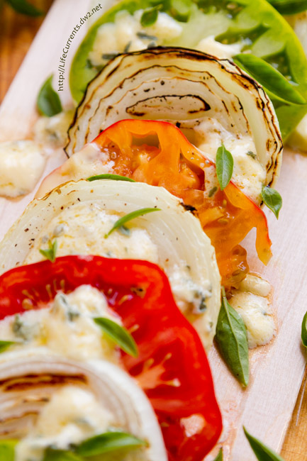 Plank Grilled Blue Cheese Caprese is a fun way to enjoy Caprese as an appetizer or a salad. The combination of sweet tomatoes, savory melted blue cheese, and smoky grilled onions is simply divine! 