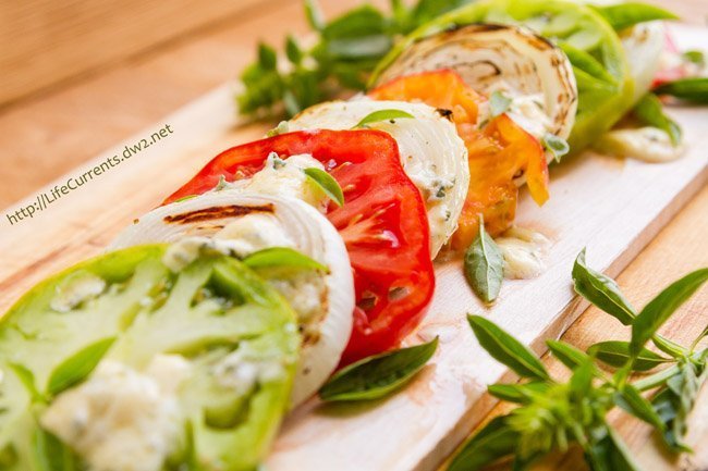 tomato slices, basil, onion slices, and blue cheese