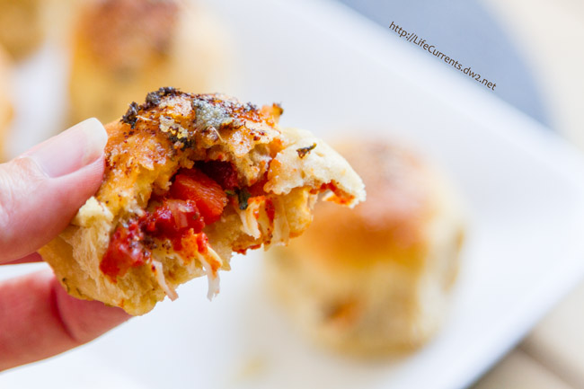 a bite taken out of a pizza snack.