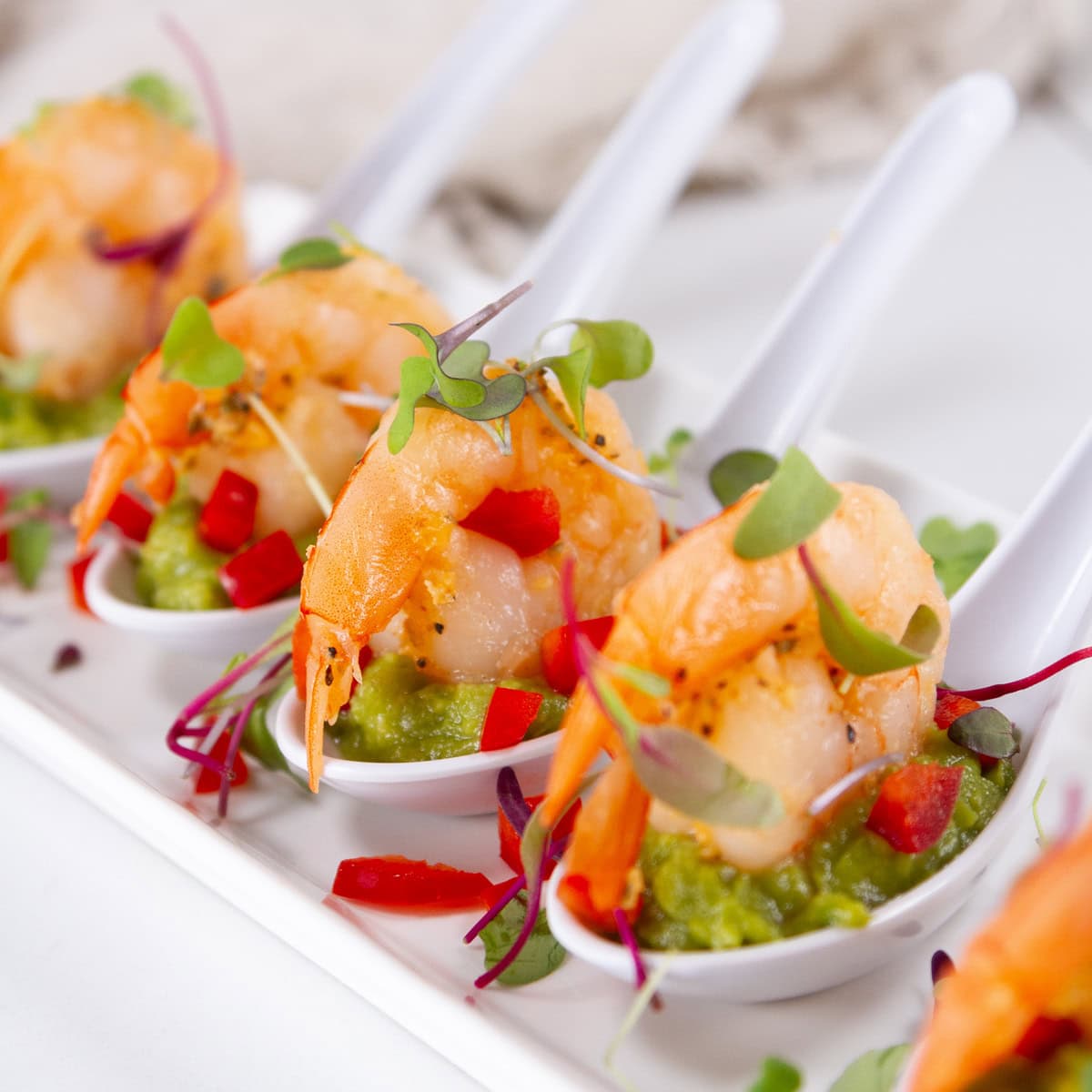 square crop of guacamole shrimp in Chinese soup spoons appetizer.