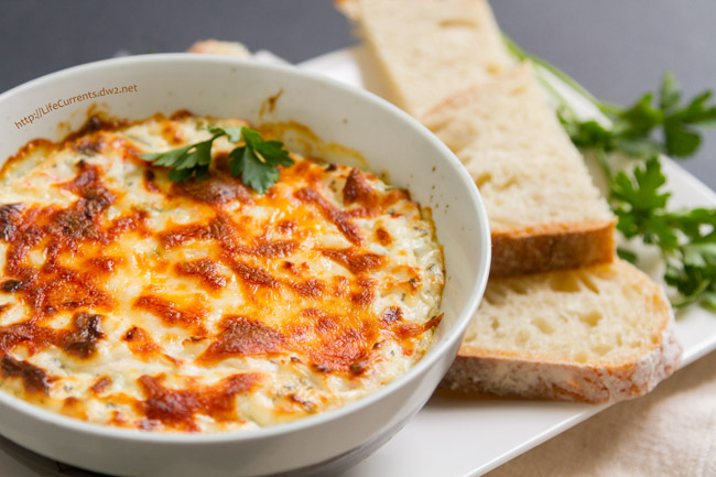 cheesy dip in a bowl served with bread