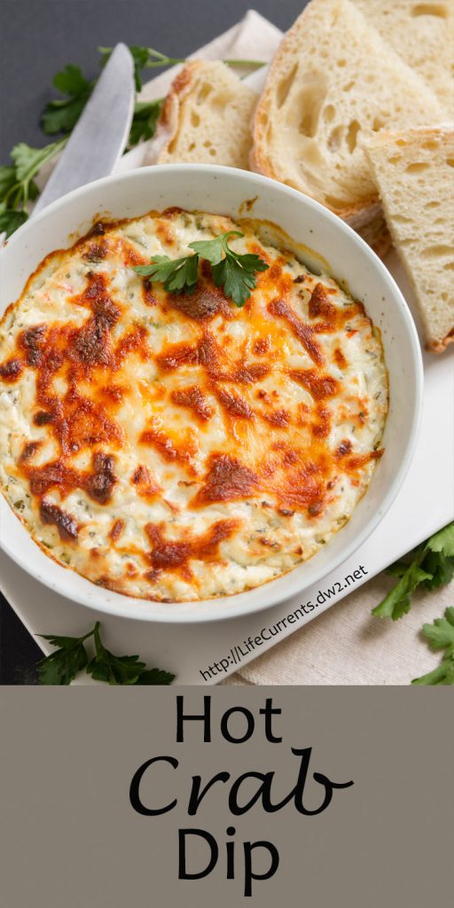 Crab dip in a bowl with some bread slices, title on bottom of image.