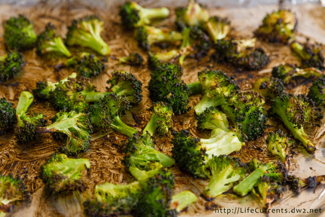 broccoli on a baking tray after coming out of the oven.