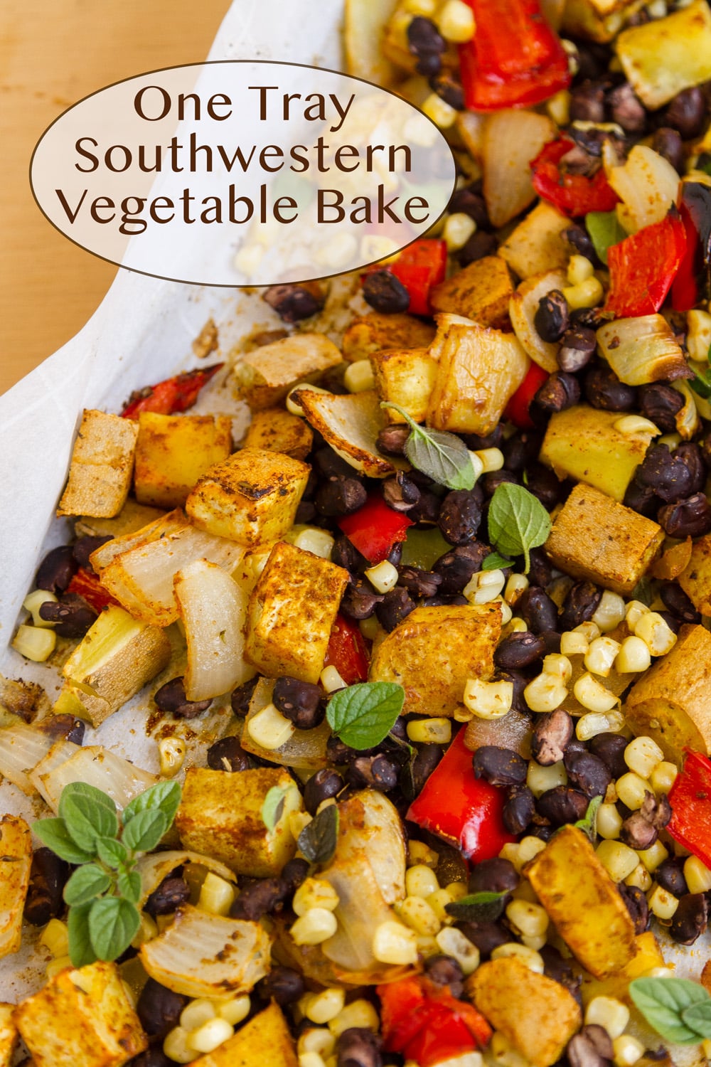 roasted vegetables in a white casserole dish.