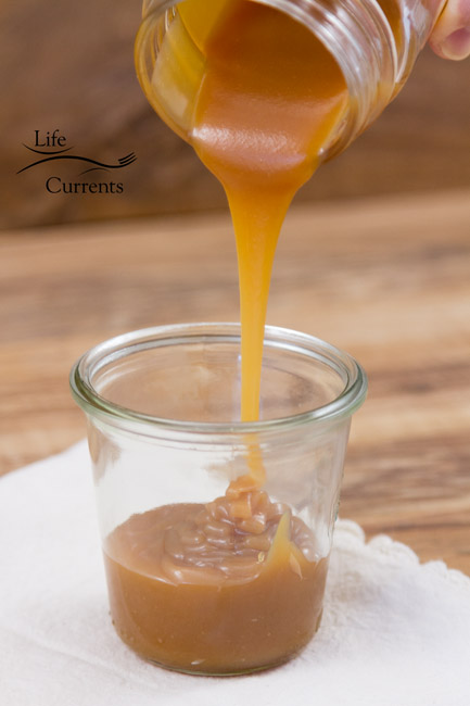 pouring caramel into a small jar
