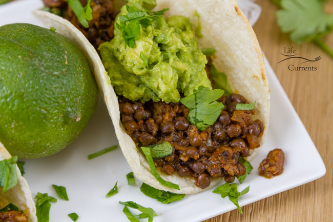 close up on tacos next to a lime.