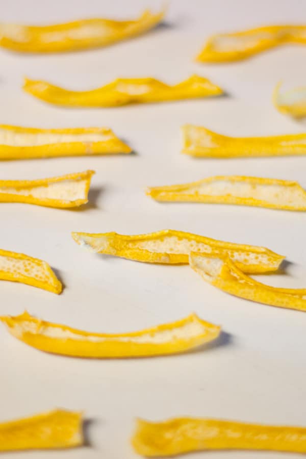 drying lemon peel on a white counter.