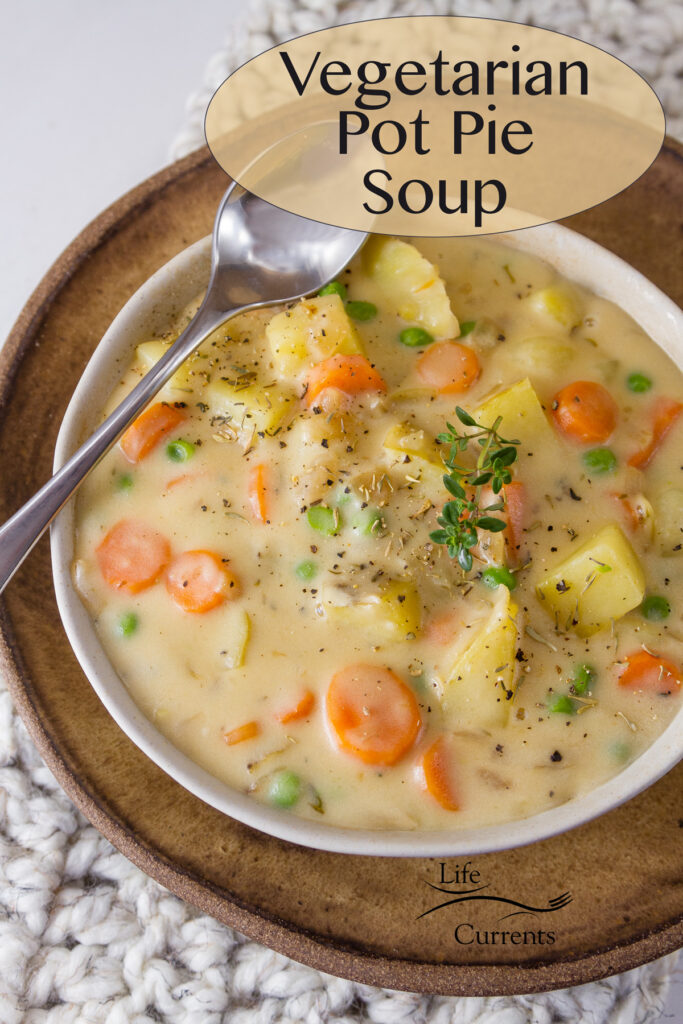 a bowl of creamy soup with a spoon on a brown serving plate. Title on image: Mom’s Vegetarian Pot Pie Soup
