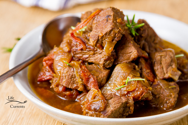 Crock Pot Braised Beef with Balsamic Tomatoes - easy to make in the slow cooker Crock Pot Braised Beef with Balsamic Tomatoes in a white bowl.