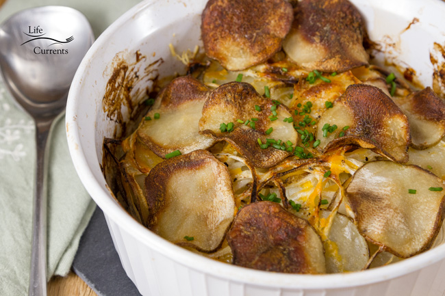 Skinny Potato and Onion Bake Casserole those potatoes and onions get good and creamy. layered sliced potatoes and onions in a casserole dish.