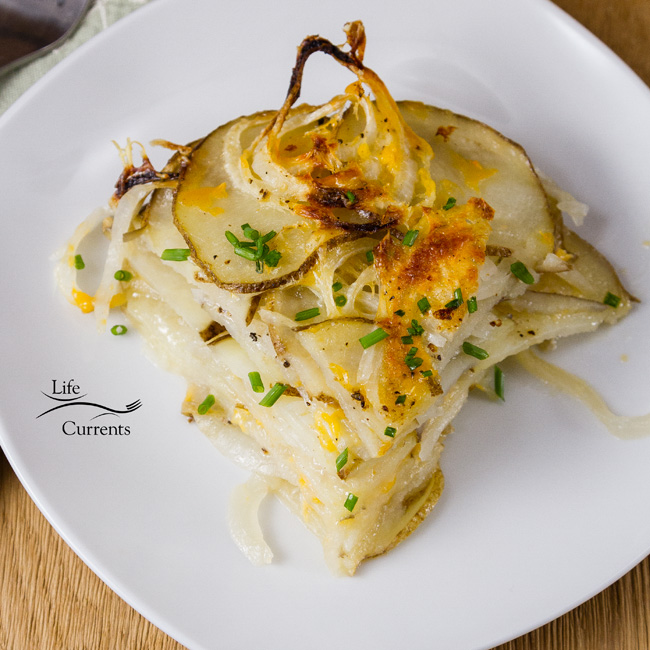 Skinny Potato and Onion Bake Easy to make and delicious to eat. A slice of a potato and onion casserole on a white plate.