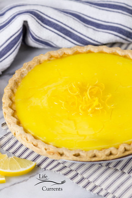 Grandma&rsquo;s Lemon Custard Pie - the whole pie that hasn't been cut into yet garnished with lemon zest 