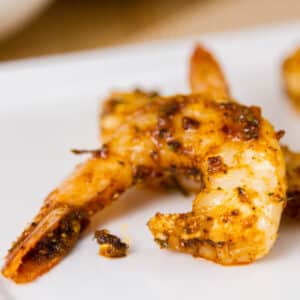 a shrimp cooked in spices on a white background.