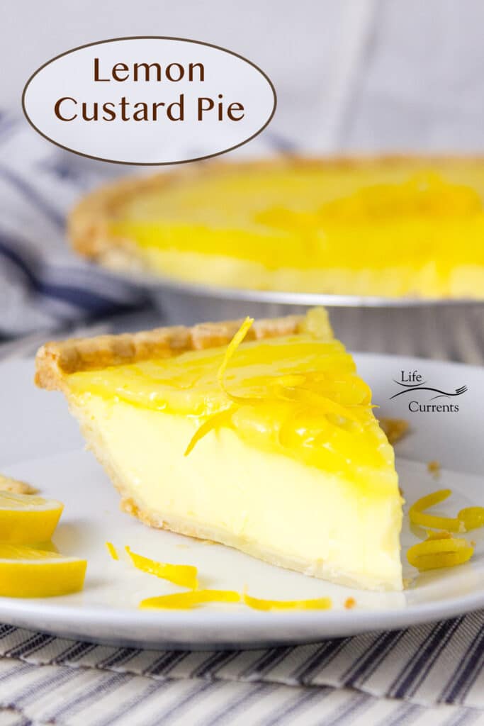 a slice of lemon custard pie on a plate in front of the whole pie in the background.