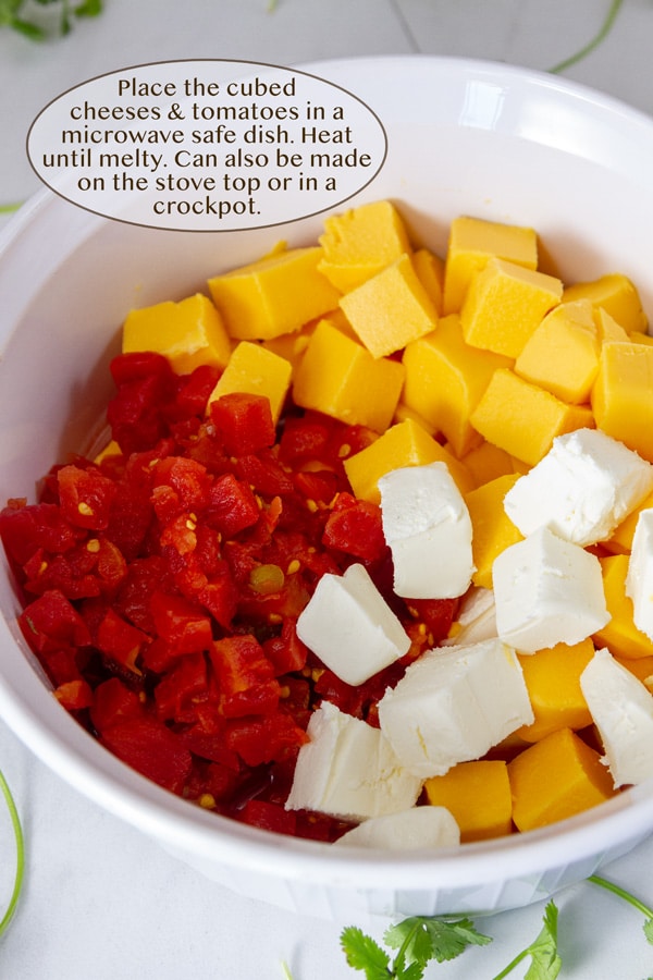 cubes of Velveeta, cream cheese, and Ro-tel tomatoes in a white dish.