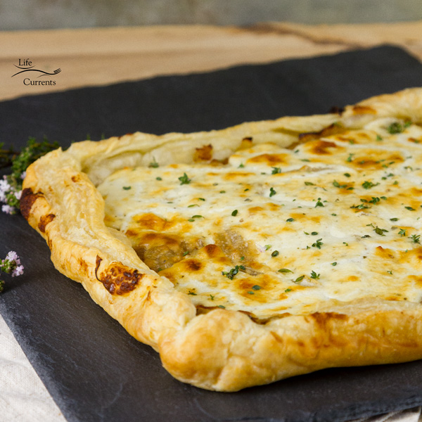 French Onion Tart - Sweet caramelized onions topped with earthy goat cheese, and all baked up in a flakey delicious puff pastry tart. 