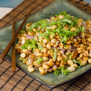 Fried Peanuts with garlic and basil are suitable as snack for any occasion. These treats are vegan and gluten-free. And, they are easy to make.