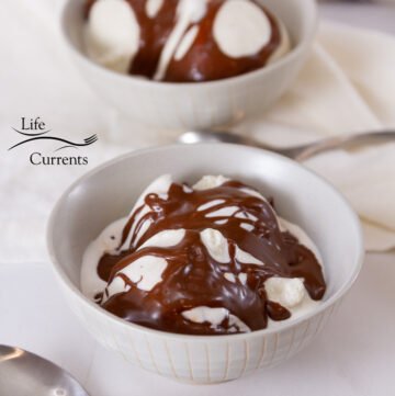 square crop of two bowls of ice cream with chcocolate sauce.