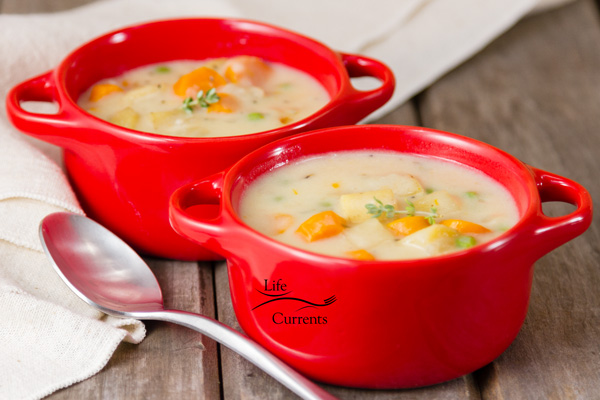 Two red bowls filled with pot pie soup.
