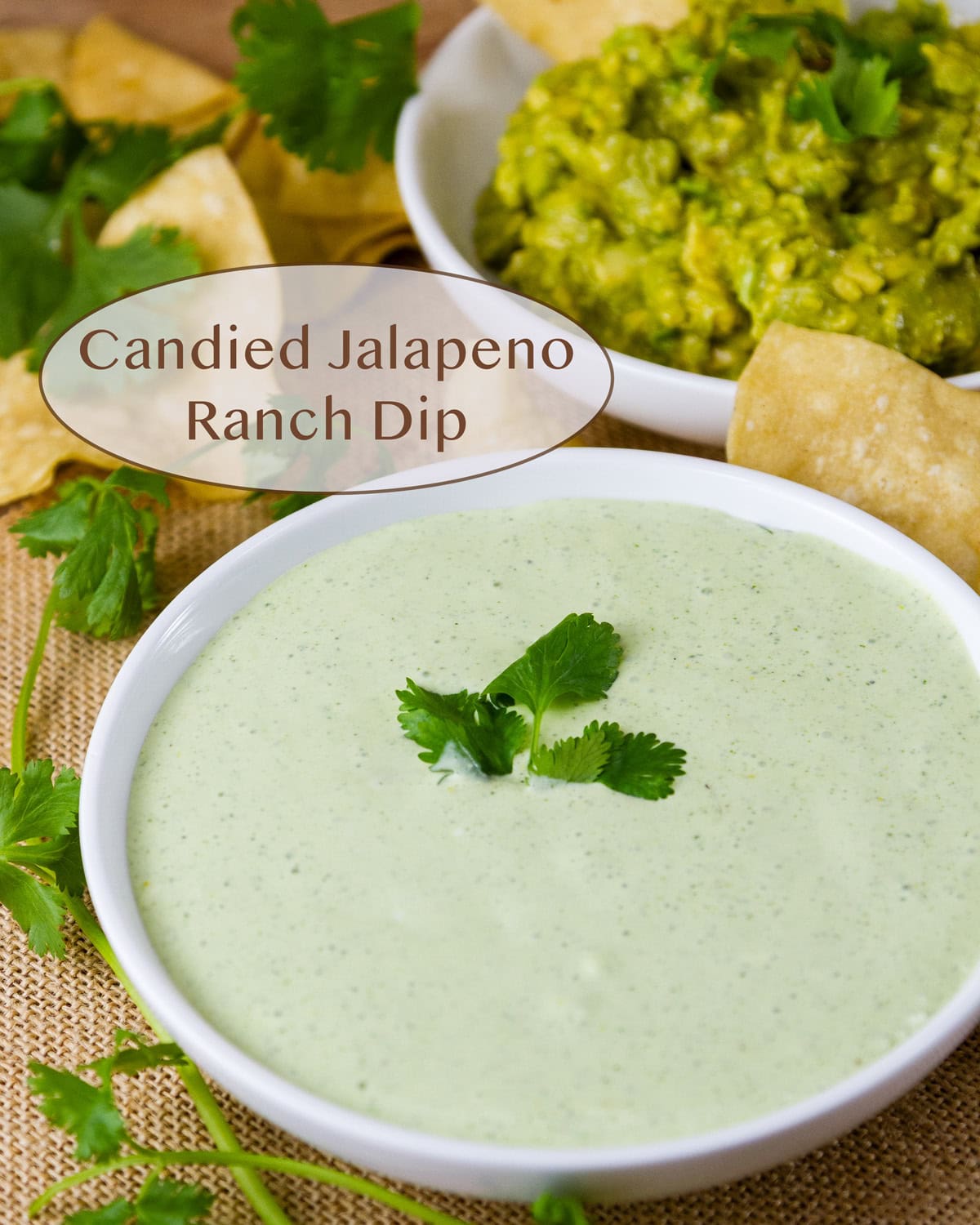 a bowl of candied jalapeno ranch dip next to a bowl of guacamole.