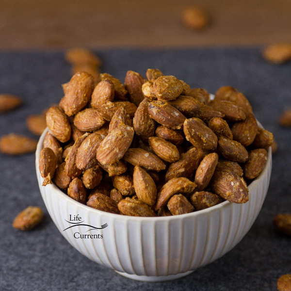 Smoked Garlic Almonds with a nice salty touch. Simple food, really. Delicious food, definitely. These are naturally vegan and gluten free. Also, these fit in a keto, Paleo, or low carb diet. a bowl full of flavored almonds