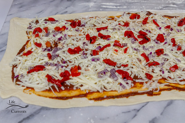 spread the cheese and toppings over it 