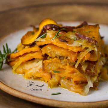 Sweet Potato Layer Bake - Sliced sweet potatoes are layered with onions and a light creamy cheese sauce, then this skinny side dish is baked up so the veggies are tender and delicious