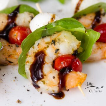 Then, these Shrimp Caprese Skewers come together easily, just line up your ingredients and skewer them on some fun party skewers. Drizzle some glaze on top. Now you have a delicious and easy party appetizer.