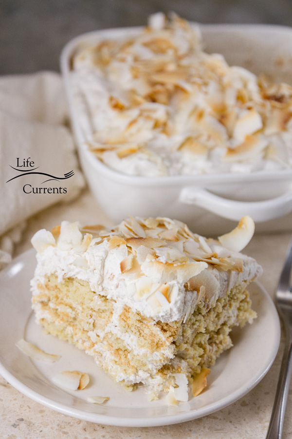 a slice of cake in the front and the rest of the ice box cake in the background
