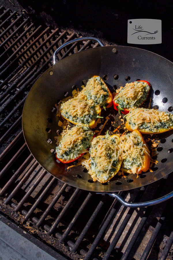 Grilled Cheesy Spinach Dip Stuffed Peppers - easy to make on the grill appetizers summer party food Spinach Dip Stuffed Peppers on the grill, topped with cornbread topping and Parmesan cheese