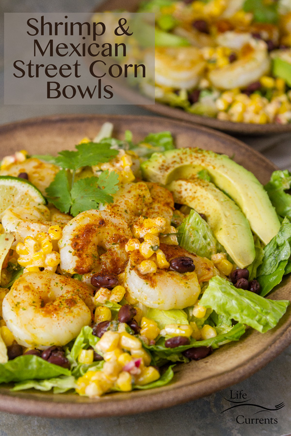 Shrimp and Mexican Street Corn Bowl Recipe healthy Perfectly spiced and sautéed shrimp served on a bed of romaine lettuce, topped with delicious Mexican street corn, that’s slathered with mayonnaise, sour cream, Cotija cheese, cilantro, and then topped with fresh avocado slices. Shrimp and Mexican Street Corn Bowl Two salad bowls in brown ceramic with lots of shrimp and avocado healthy delicious