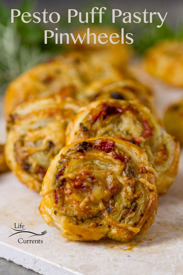 Pesto Puff Pastry Pinwheels are super easy to make pinwheel appetizers with basil pesto, roasted red peppers, sun dried tomatoes, and Parmesan cheese. 
