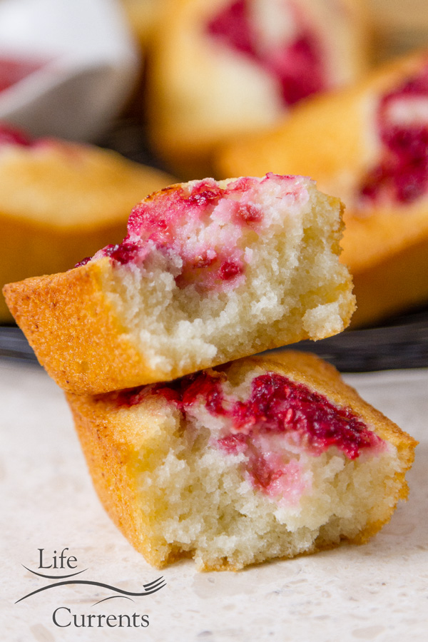 Almond Cakes with Roasted Raspberry Swirl broken open so you can see the light moist texture of the cake