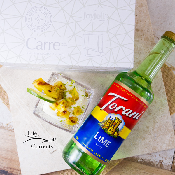 Parfaits next to a large bottle of Torani syrup