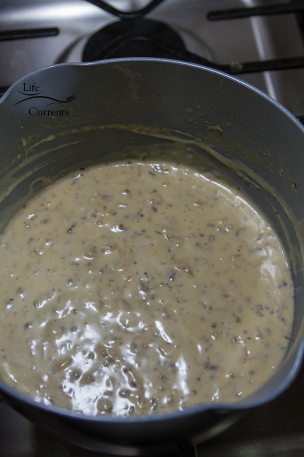 Cooked homemade condensed cream of mushroom soup cooking in a pan