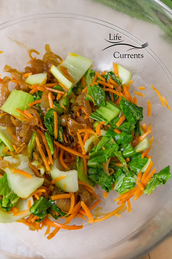 stir fried bok choy, carrots, and shallots in a glass bowl