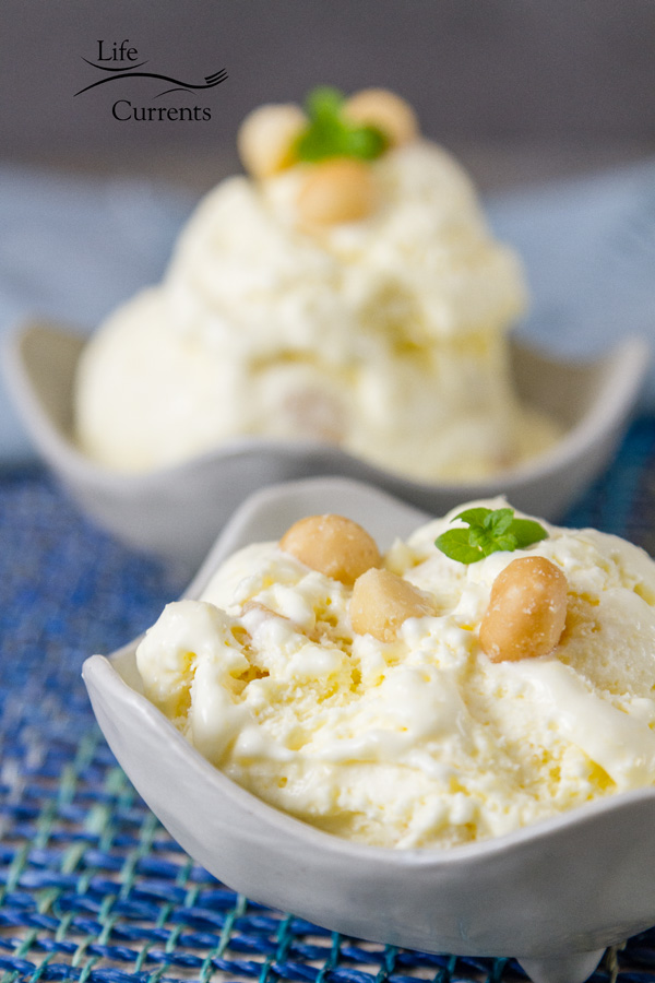 2 bowls of pineapple ice cream in white bowls on blue fabric 