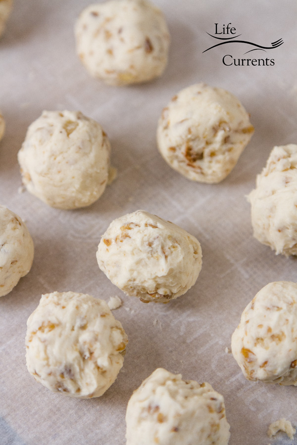 Pecan Bourbon Balls filling that's been shaped into balls on parchment paper 