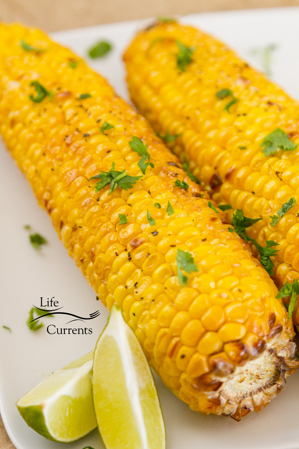 two ears of corn with lime wedges 