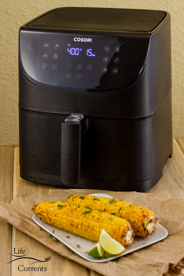 The new COSORI Smart WiFi Air Fryer 5.8QT and two ears of roasted corn