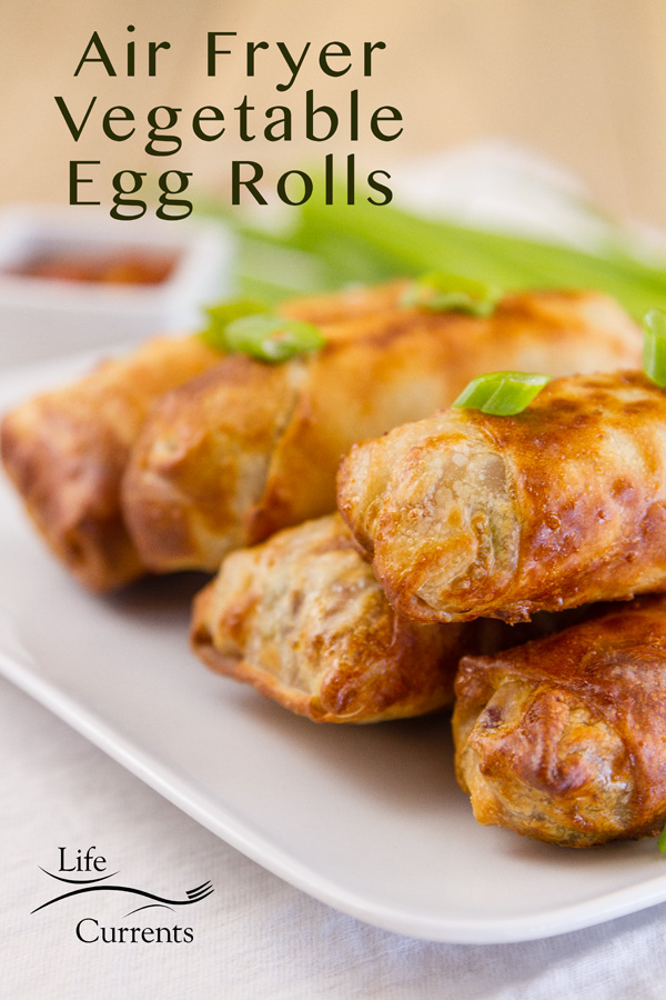 Egg Rolls stacked on a plate garnished with green onions. Plus the title