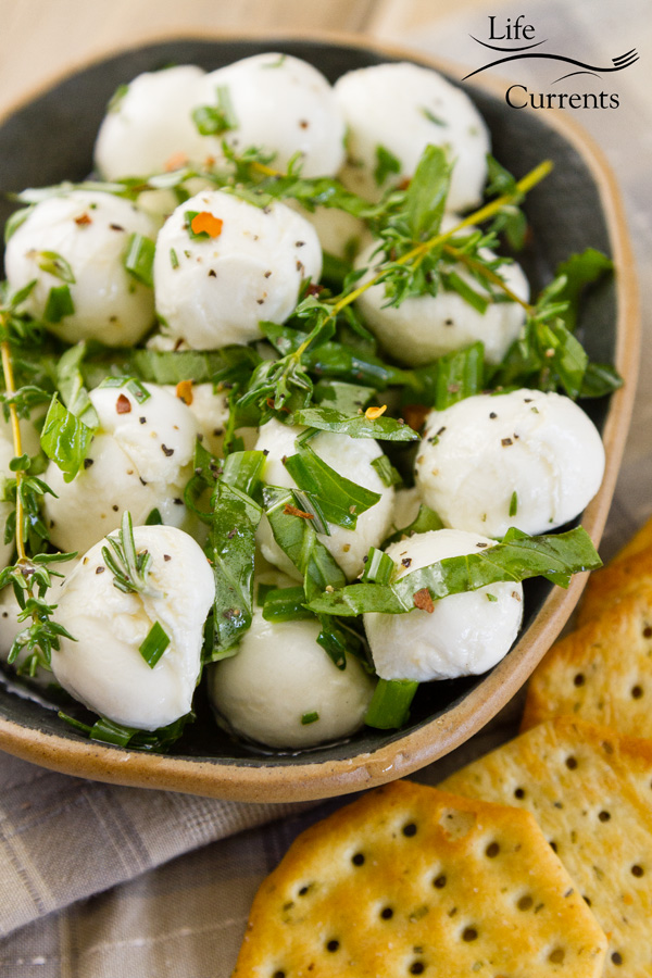Marinated Mozzarella Appetizer Recipe in a bowl served with crackers 
