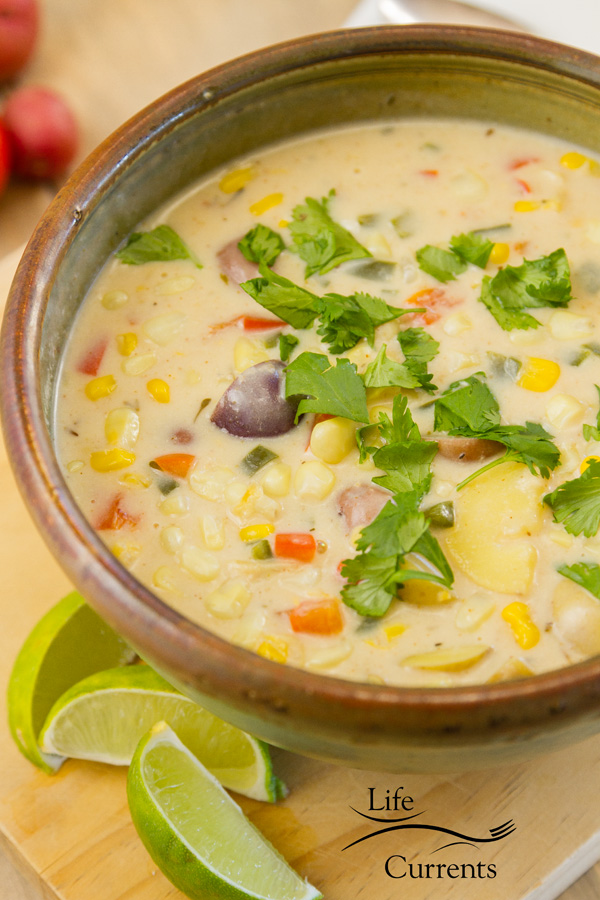 Southwestern Corn Chowder in a cermaic bowl with lime wedges