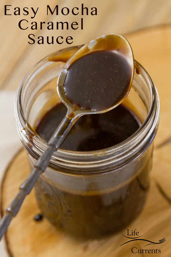 Easy Mocha Caramel Sauce in a mason jar with as spoon on top of the jar and sauce in the bowl of the spoon